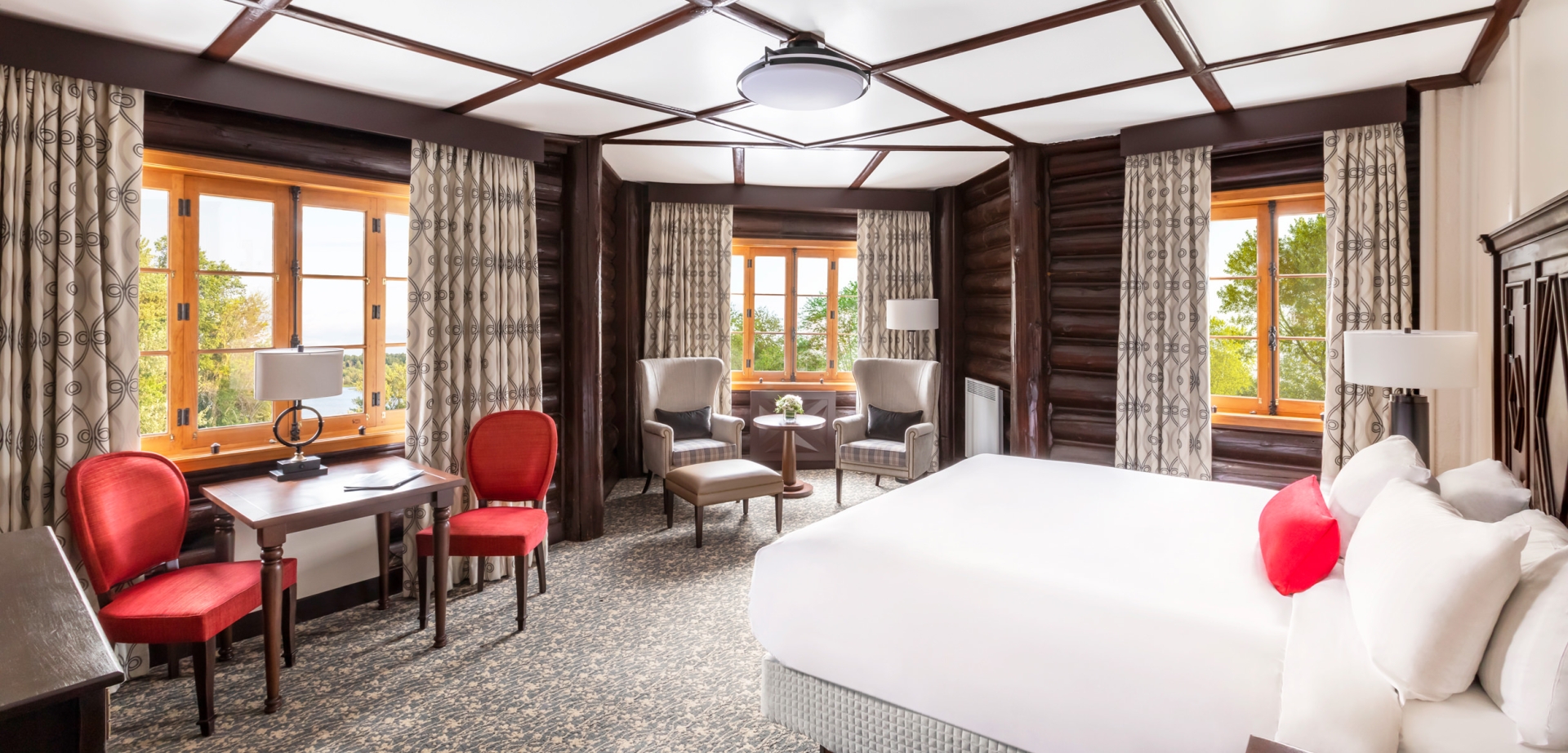 large bedroom with sitting area and small table
