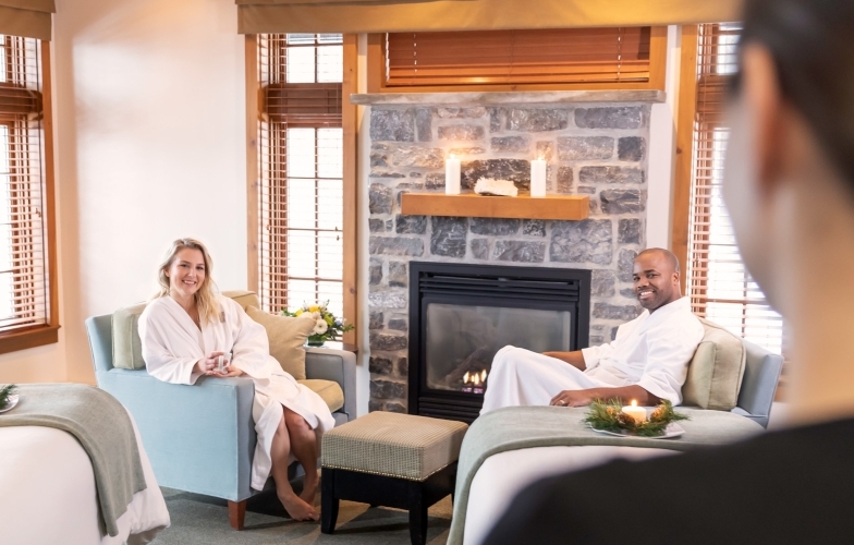 A couple waiting for their massages in front of a fire place