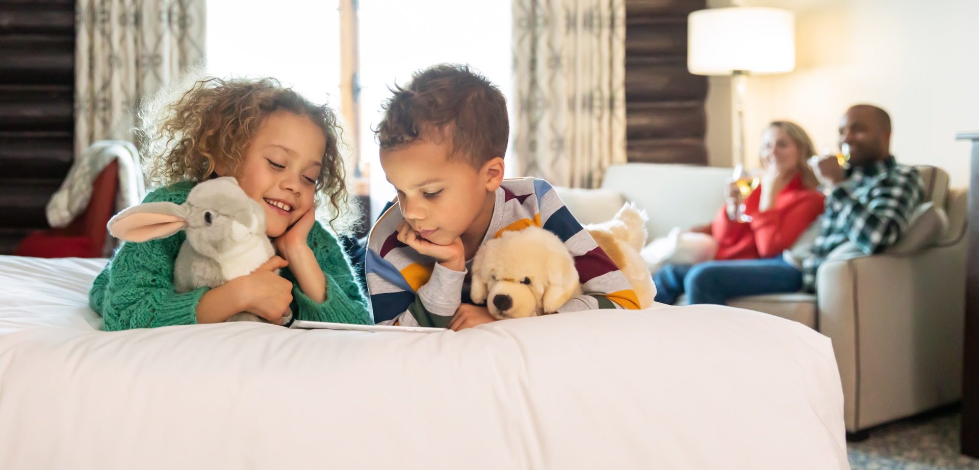 siblings playing while the parents are watching
