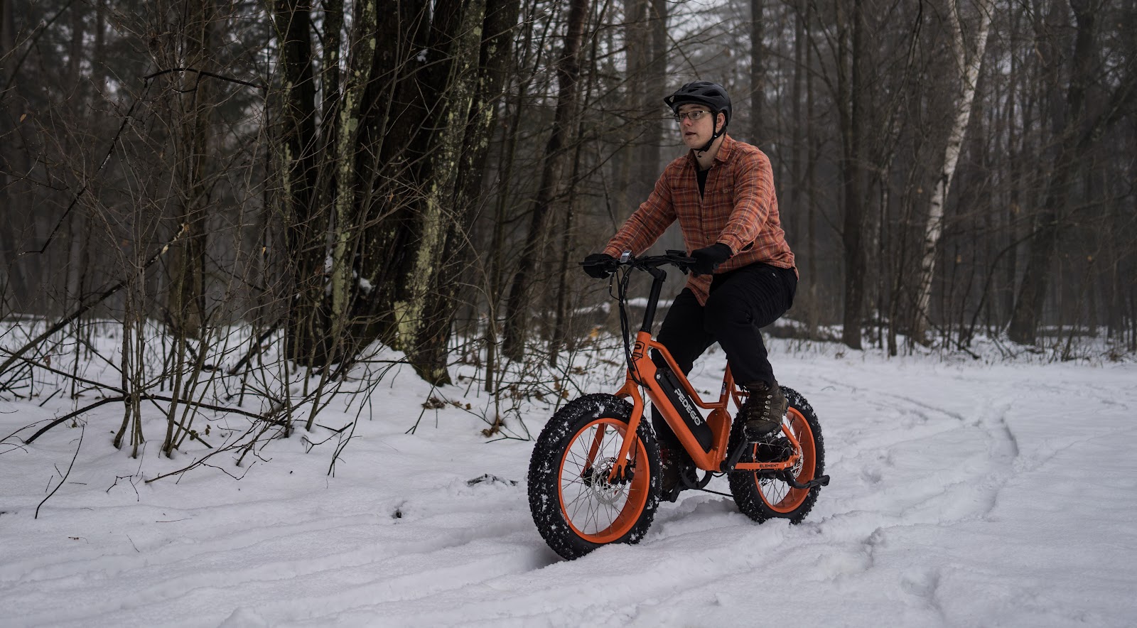 man riding a fat bike in the snow